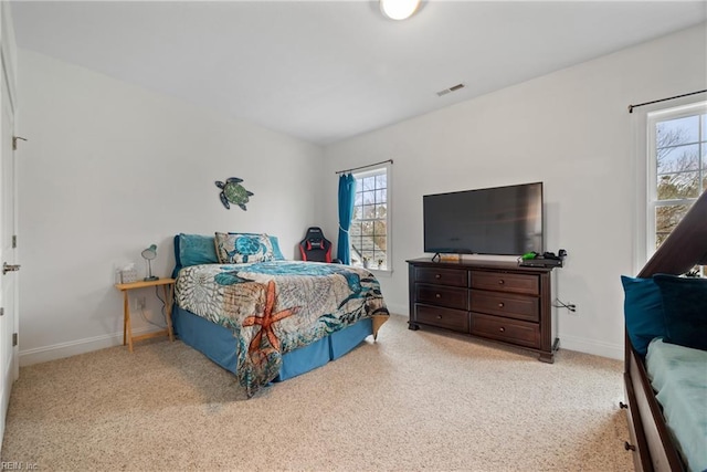 bedroom featuring light carpet