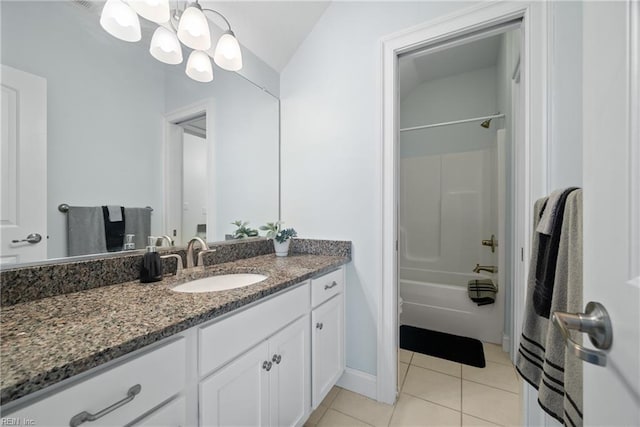 bathroom featuring tile patterned flooring, vanity, a notable chandelier, and  shower combination