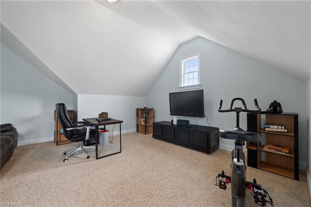 carpeted home office with vaulted ceiling and a textured ceiling