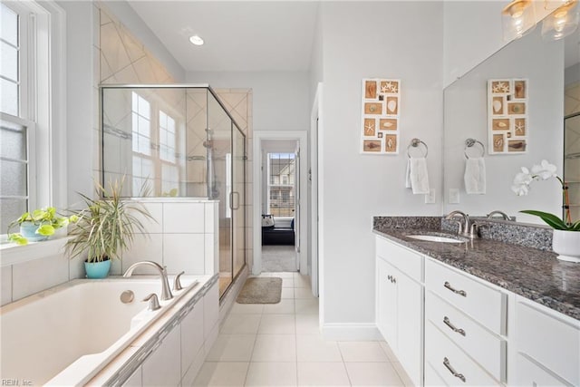 bathroom with vanity, tile patterned flooring, and shower with separate bathtub