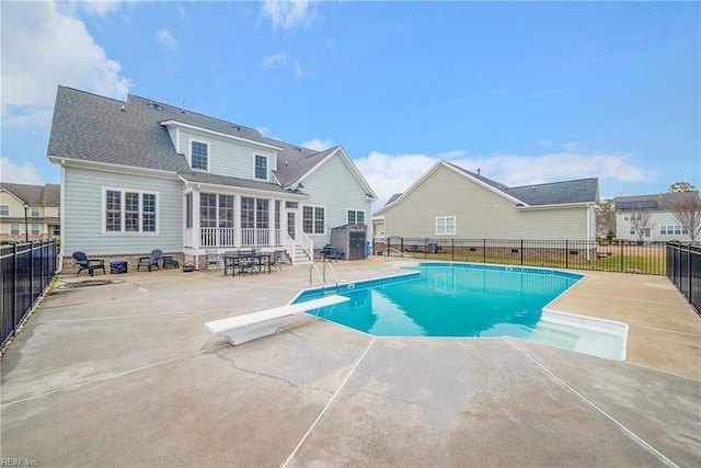 view of pool featuring a patio and a diving board