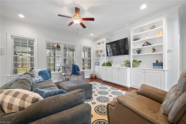 living room featuring wood-type flooring, ceiling fan, and crown molding