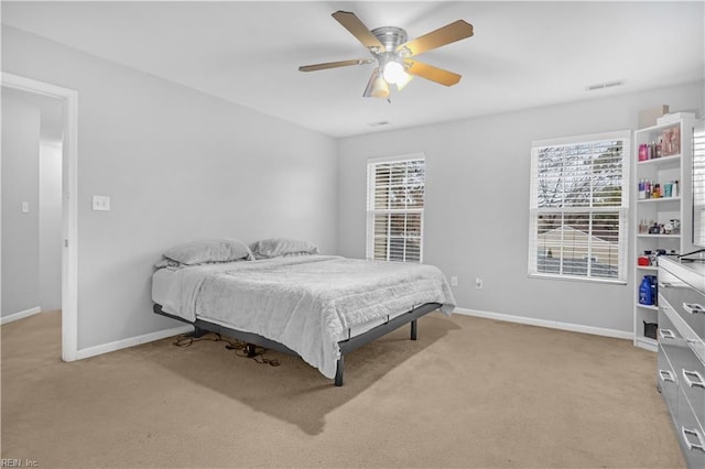 bedroom featuring light carpet and ceiling fan