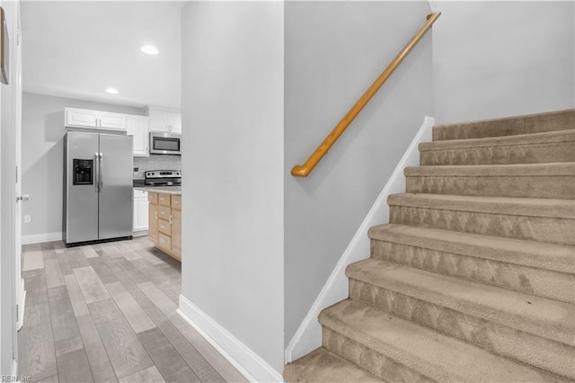 staircase featuring wood-type flooring