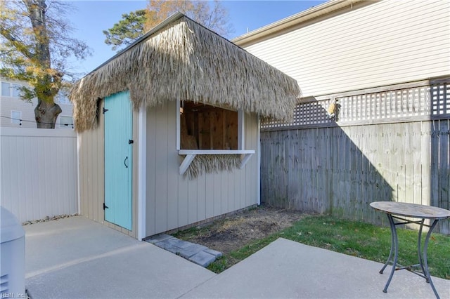 view of outbuilding featuring a fenced backyard and an outdoor structure