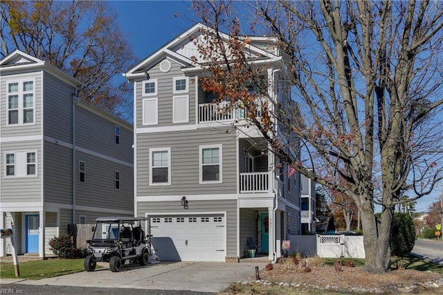 view of front of house with driveway, a balcony, and an attached garage