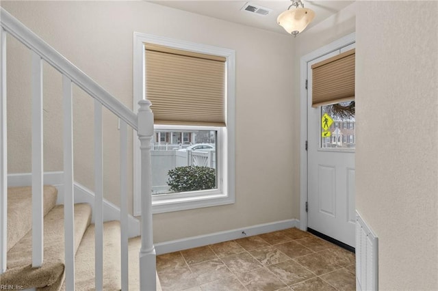 entryway featuring stairway, visible vents, and baseboards