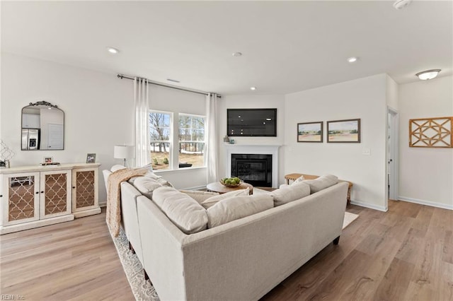 129 Getty Rd, Suffolk, VA 23434 - living area with wood finished floors, a glass covered fireplace, recessed lighting, and baseboards