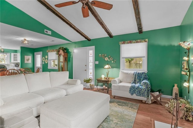 living room featuring lofted ceiling with beams, light hardwood / wood-style floors, and ceiling fan