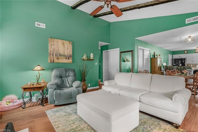 living room with vaulted ceiling, ceiling fan, and light hardwood / wood-style floors