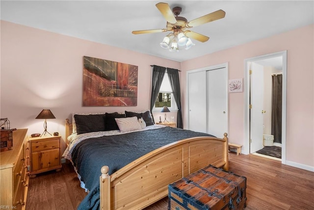 bedroom with dark hardwood / wood-style flooring, ensuite bath, a closet, and ceiling fan