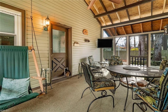 sunroom / solarium with vaulted ceiling with beams