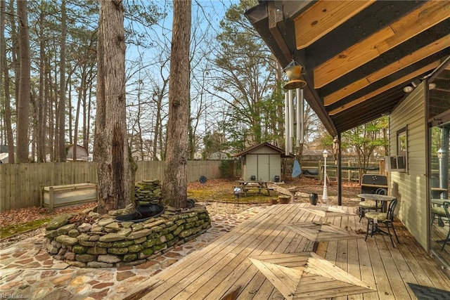 wooden terrace with a storage shed