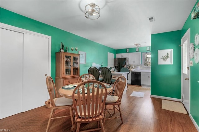 dining area with light hardwood / wood-style flooring