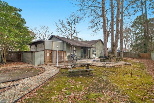 back of house featuring a lawn