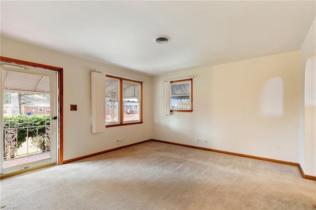 unfurnished room featuring light carpet