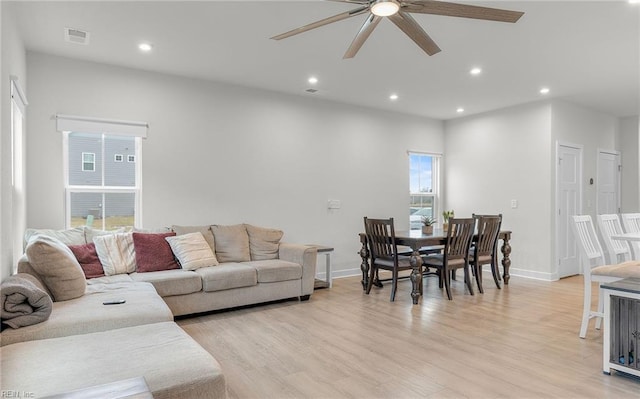 living room with ceiling fan and light hardwood / wood-style floors