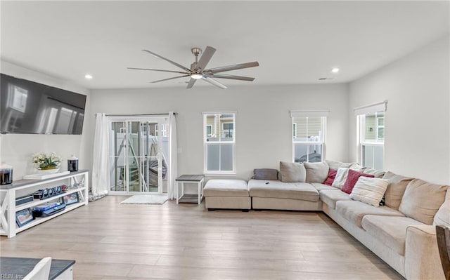 living room featuring ceiling fan and light wood-type flooring