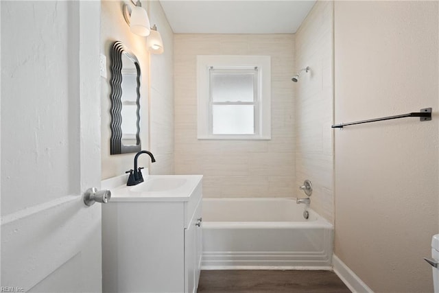 bathroom featuring vanity, hardwood / wood-style flooring, and tiled shower / bath combo