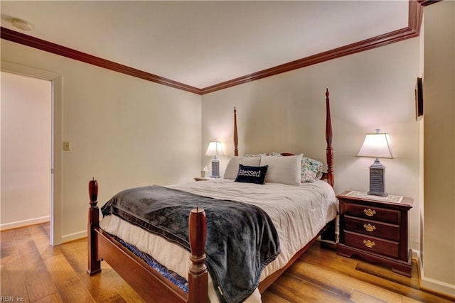 bedroom with light hardwood / wood-style flooring and ornamental molding