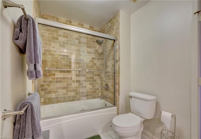 bathroom featuring bath / shower combo with glass door and toilet