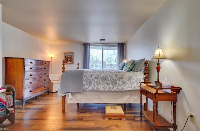 bedroom with hardwood / wood-style floors