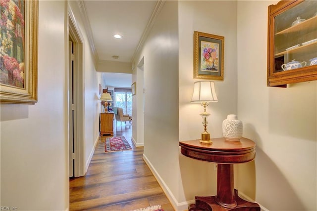 hallway with crown molding and dark wood-type flooring