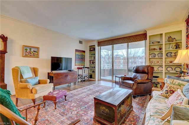 living room featuring ornamental molding and wood-type flooring