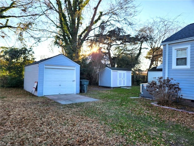 view of yard featuring a garage and a storage unit