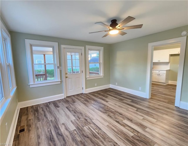 interior space with ceiling fan and light hardwood / wood-style flooring