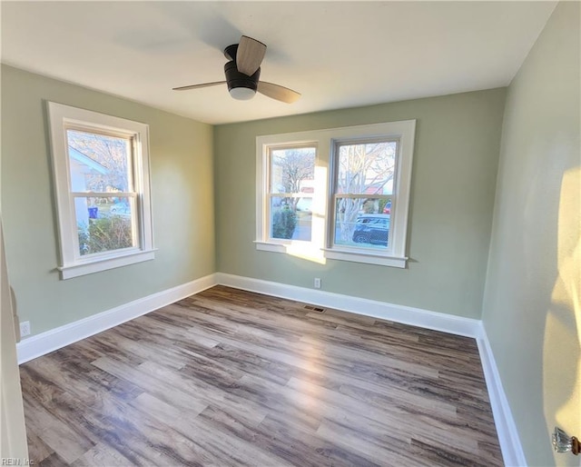 empty room featuring wood-type flooring and ceiling fan