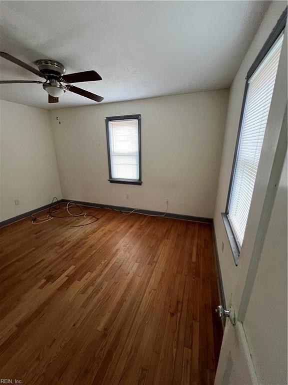 spare room with ceiling fan and dark hardwood / wood-style flooring