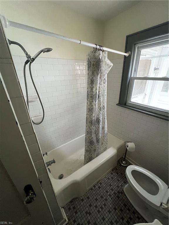 bathroom featuring tile patterned flooring, shower / tub combo, and toilet