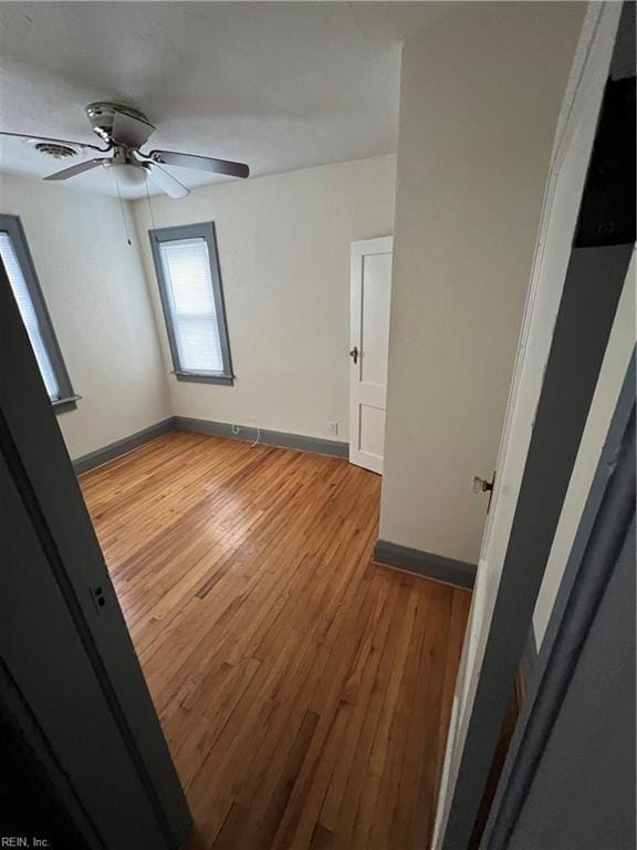 interior space with light hardwood / wood-style floors and ceiling fan