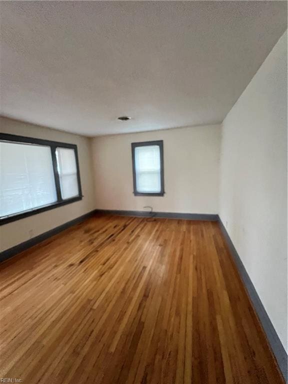 empty room featuring hardwood / wood-style floors and a textured ceiling