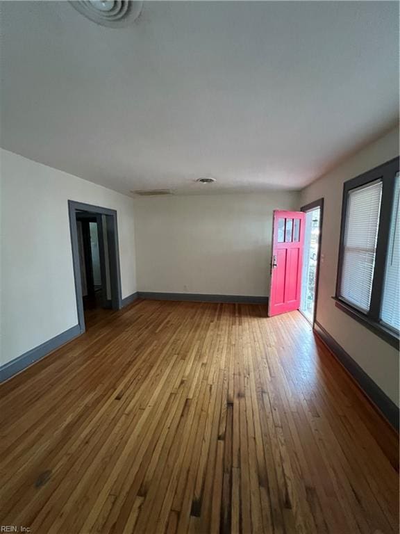 spare room with hardwood / wood-style floors