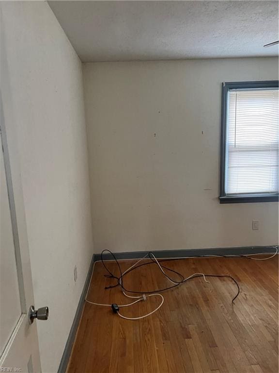 empty room featuring hardwood / wood-style floors and a textured ceiling