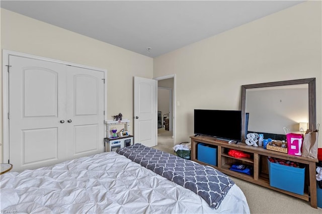 bedroom with a closet and light carpet