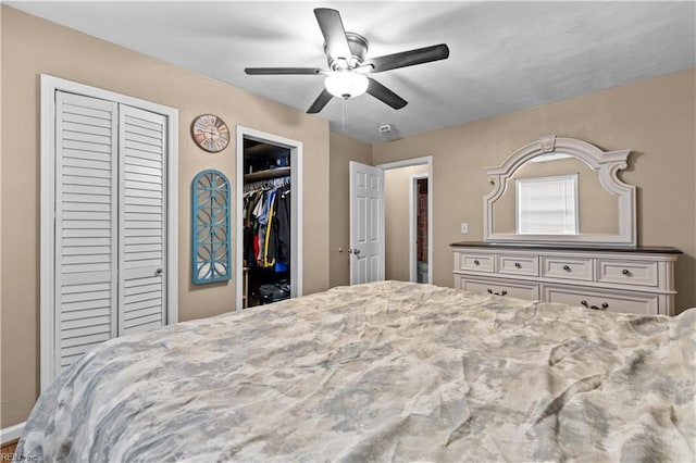 bedroom with multiple closets and ceiling fan