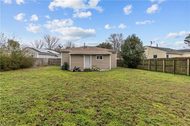 rear view of house with a yard