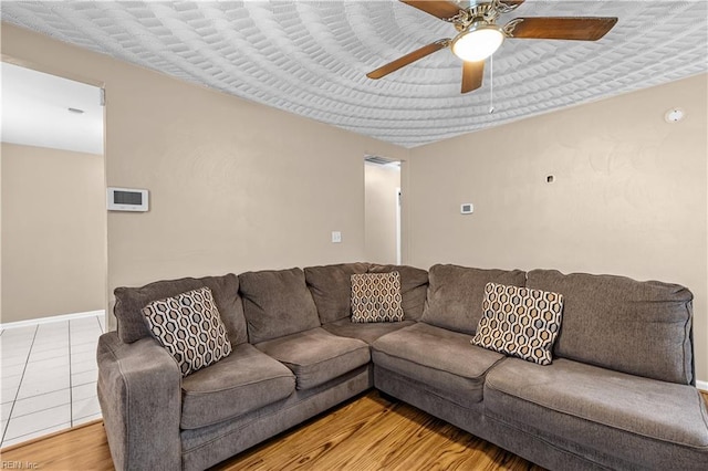 living room with tile patterned flooring and ceiling fan