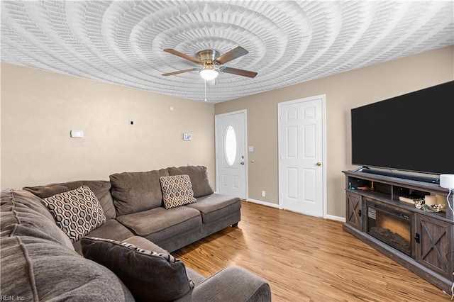 living room featuring light hardwood / wood-style floors and ceiling fan