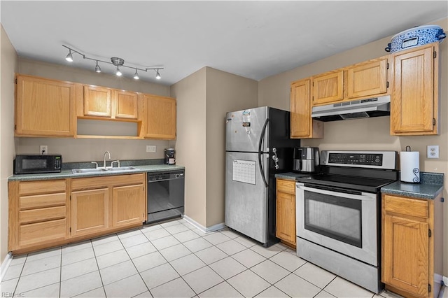 kitchen with sink, light tile patterned floors, light brown cabinetry, and black appliances