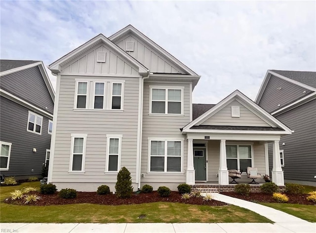 view of front of home with a porch and a front yard