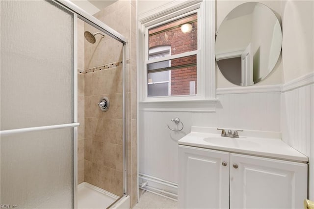 bathroom with a shower with door and vanity