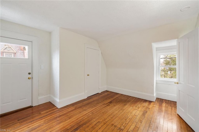 bonus room with wood-type flooring and lofted ceiling