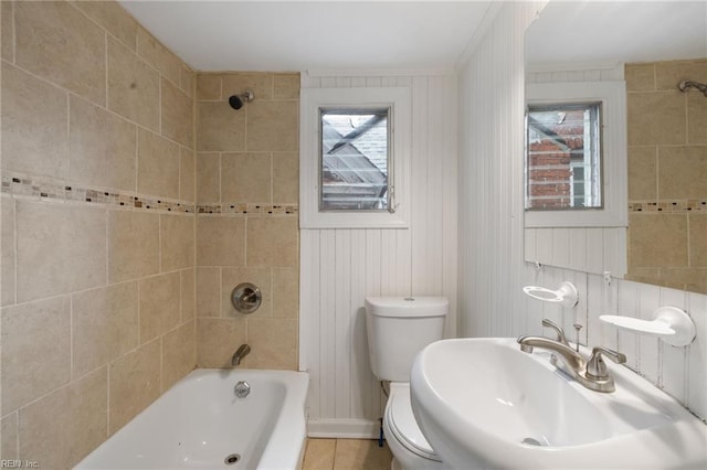 full bathroom featuring sink, toilet, and tiled shower / bath