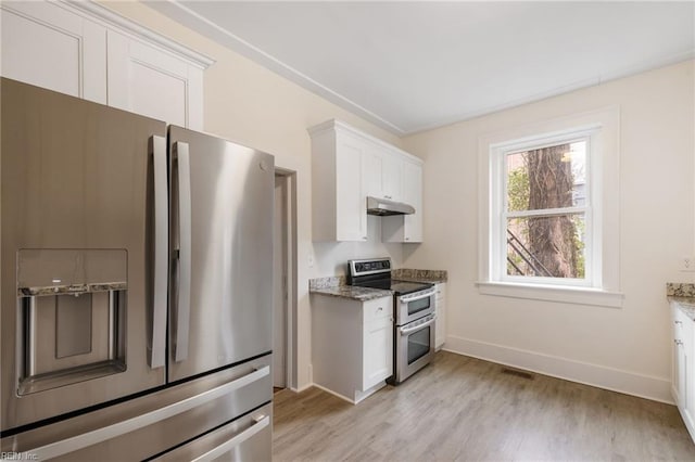 kitchen featuring stone counters, appliances with stainless steel finishes, light hardwood / wood-style flooring, and white cabinets