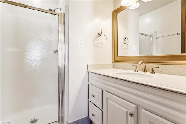 bathroom featuring vanity and an enclosed shower