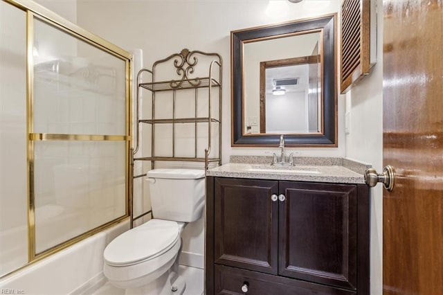 full bathroom with vanity, toilet, and combined bath / shower with glass door